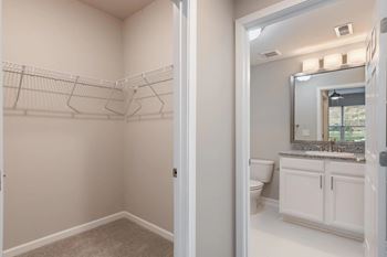 A bathroom with a toilet and a sink and a mirror